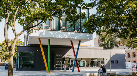 In front of the entrance to the Campus Welcome Centre with its colourful columns (c) Jana Dünnhaupt, University of Magdeburg