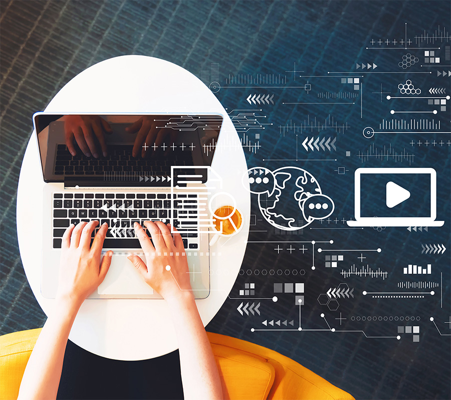 Hände von oben tippen auf einem Laptop daneben grafische Elemente zum Thema Digitalisierung (c) Shutterstock_TierneyMJ